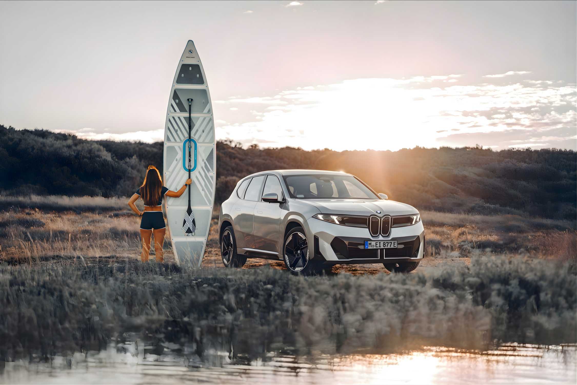 BMW iX3 shown during a leisure journey in a rural landscape