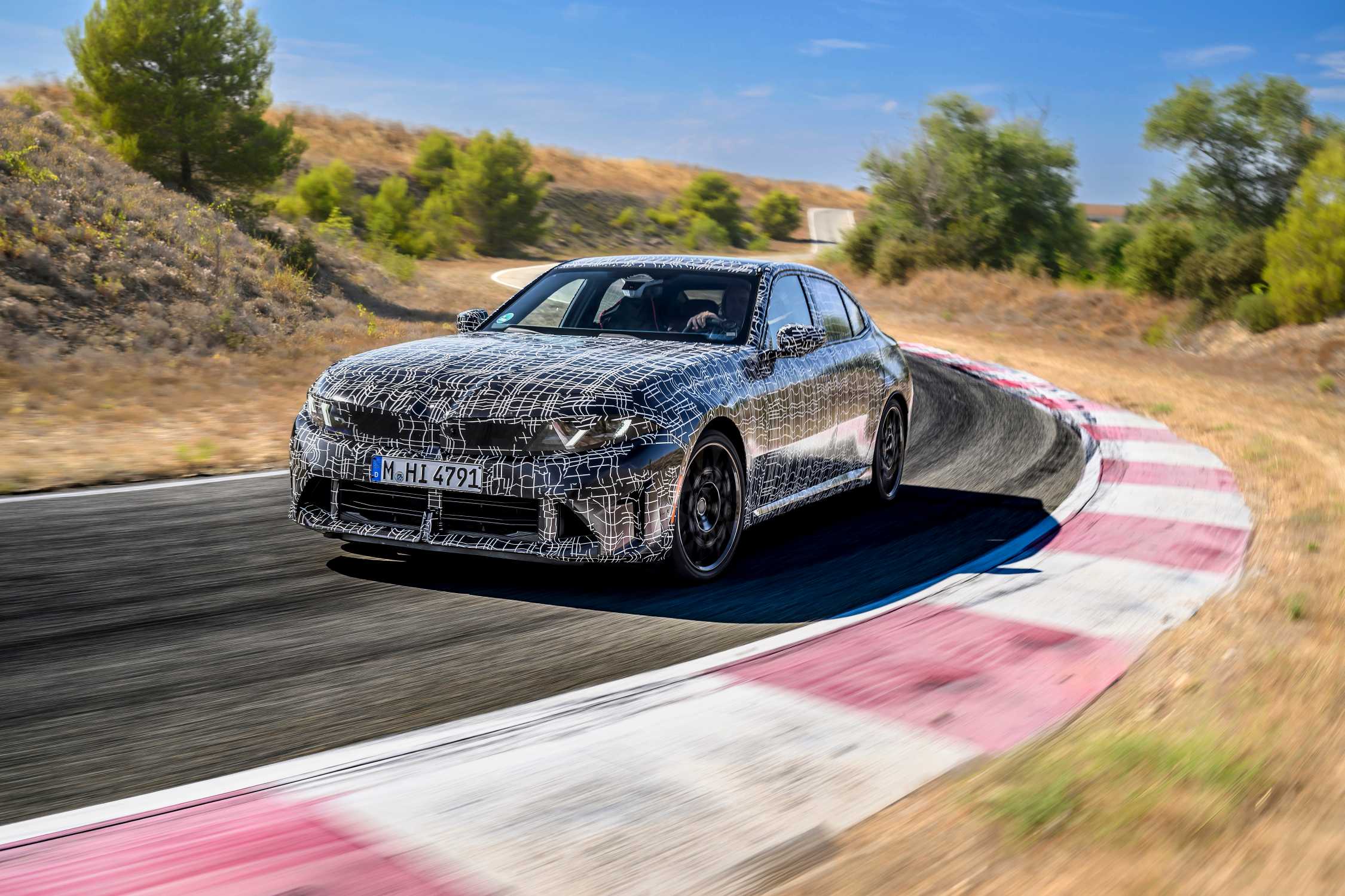 Camouflaged prototypes of the new BMW 3 Series during driving dynamics testing at Miramas