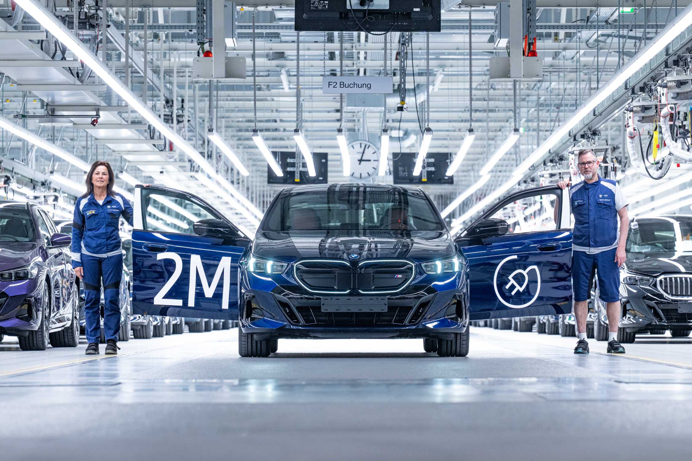 BMW Group's two-millionth all-electric vehicle, a BMW i5 M60 xDrive sedan in Tansanit Blue, at Dingolfing