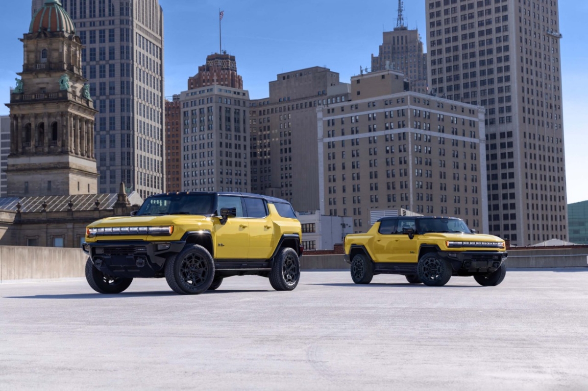 Yellow GMC HUMMER EV Pickup and SUV displayed on a Detroit rooftop