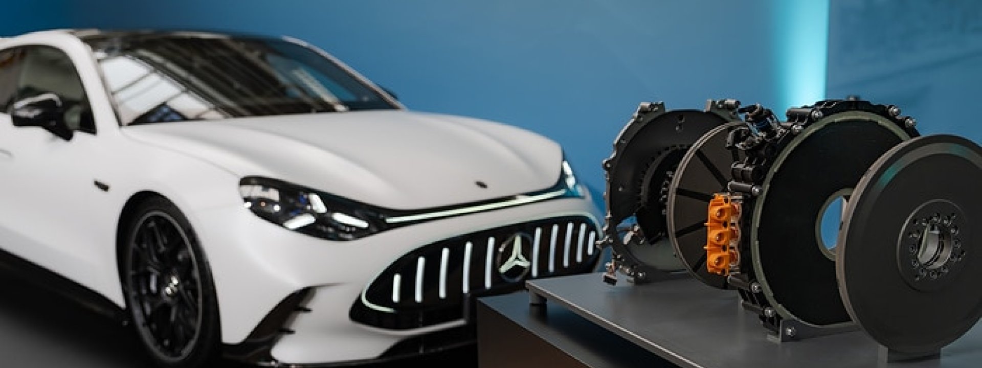 Mercedes-Benz electric axial-flux motor displayed beside a white Mercedes-Benz vehicle
