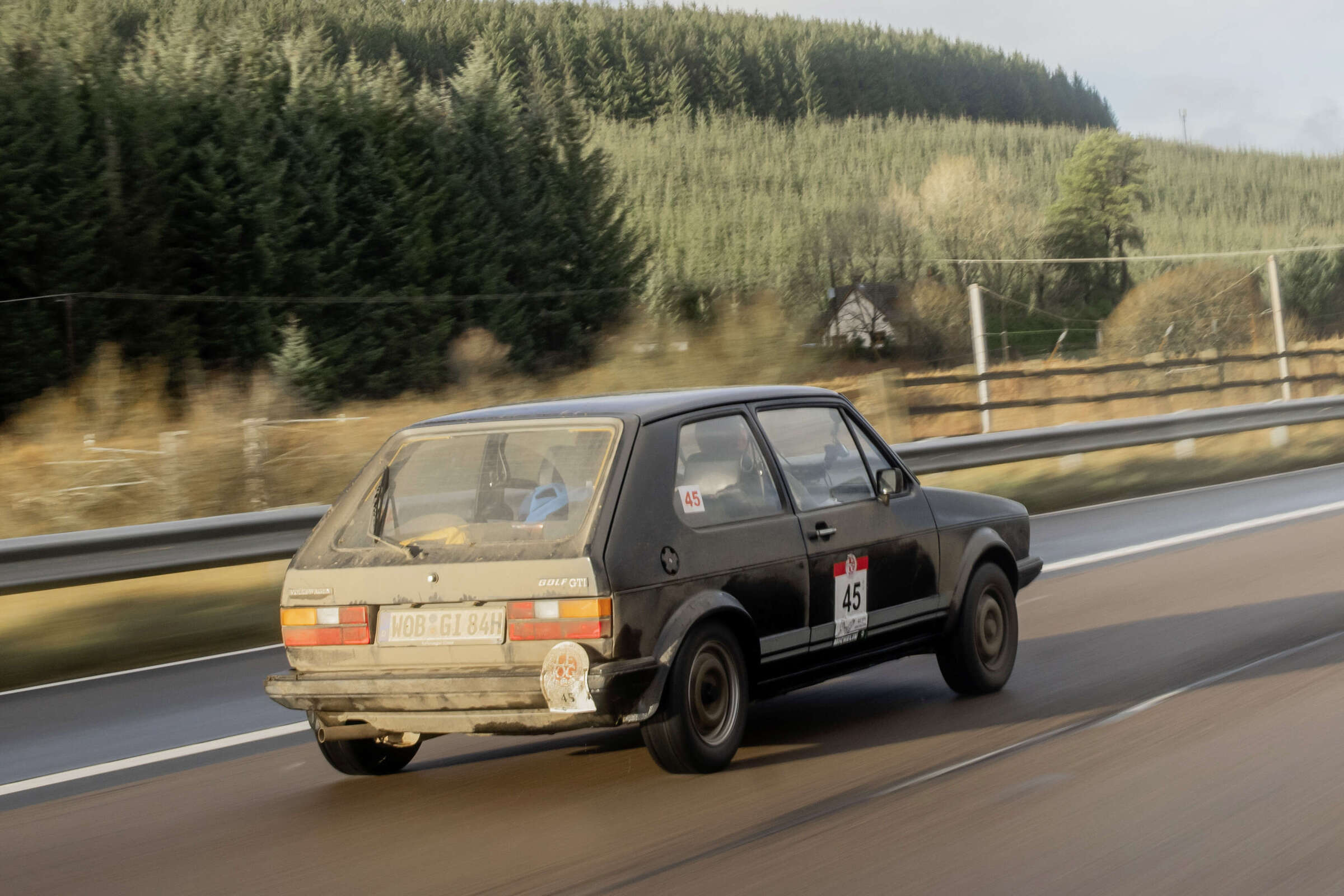 A 1979 Mars Red Volkswagen Golf I GTI and a 1983 Brilliant Black Golf I GTI with original rally patina